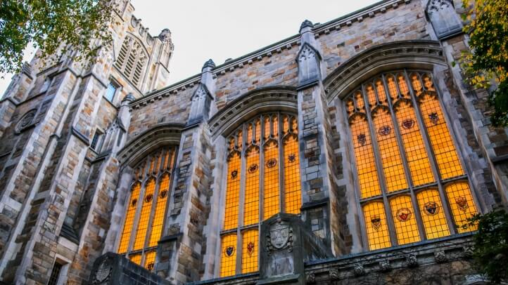 Exterior view of the Michigan Law Reading Room illuminated windows during dusk