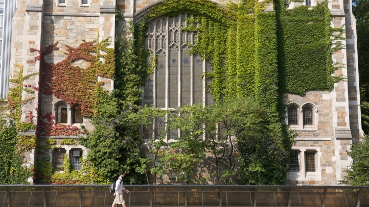 Person walking across the sidewalk in front the Reading Room