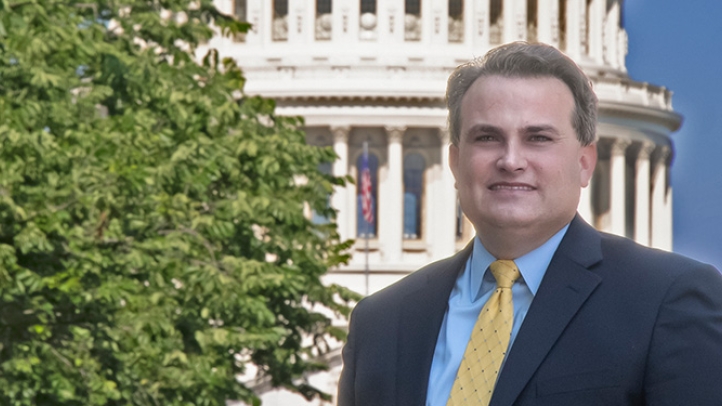 Professor Chris Walker with the U.S. capital in the background