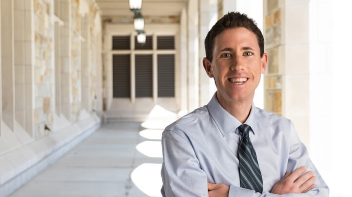 Patrick Barry standing under the cloisters at the UM law school