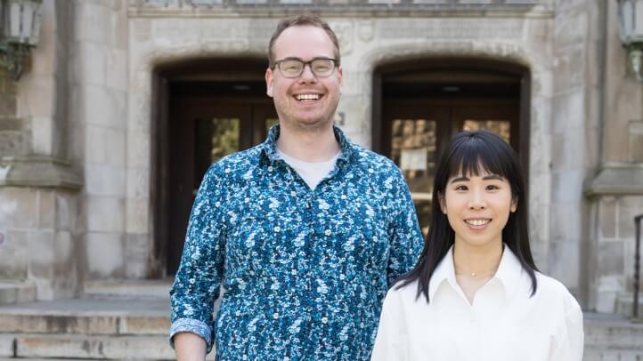 Two people standing in front of a building