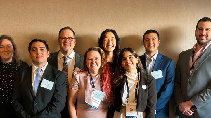 Group of professors and Michigan law school students smiling for a photo