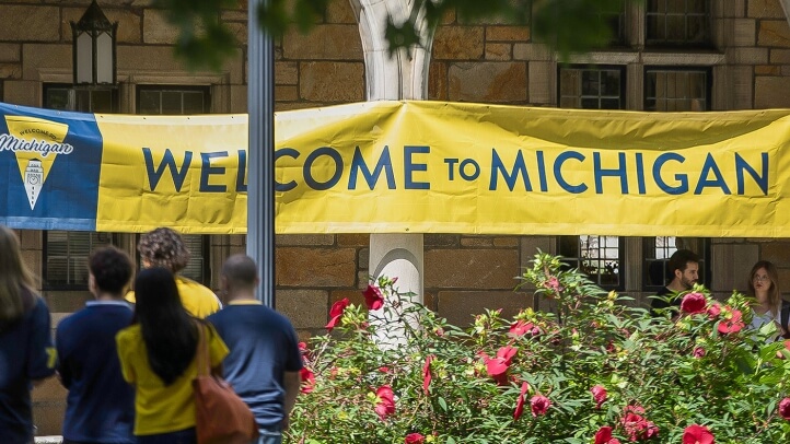 A "Welcome to Michigan" banner is hung outside the Lawyers Club, welcoming all who pass by.
