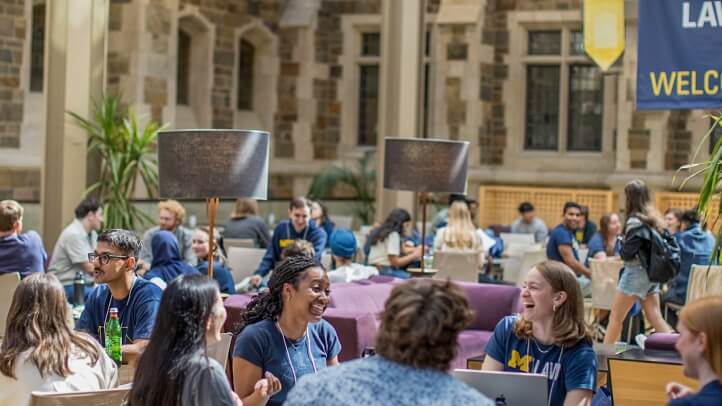 A group of Michigan Law students sitting together in the upper commons.