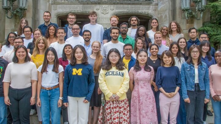 A group of LLM students pose for a portrait outside the Reading Room.