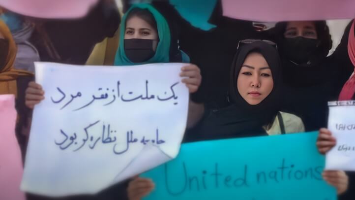 A group of women holding protest signs.