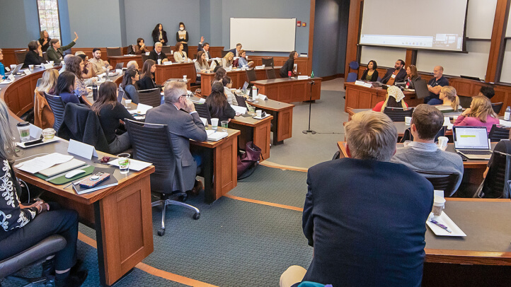 Attendees of the Transnational Law Symposium ask panelists questions.