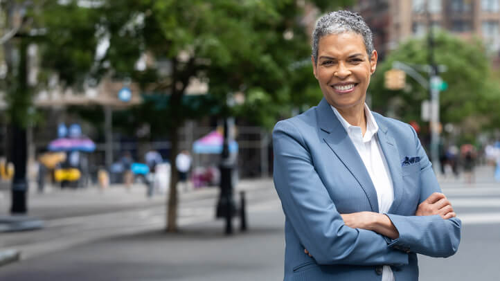 Michelle Adams portrait with a cityscape in the background.
