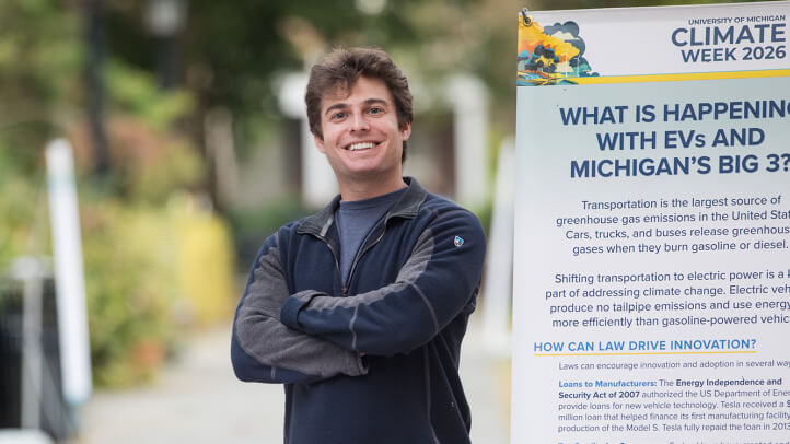 Ben Korn next to the Climate Week Exhibit in the Law Quad.