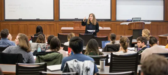 Professor Eve Primus teaching in front of a full classroom