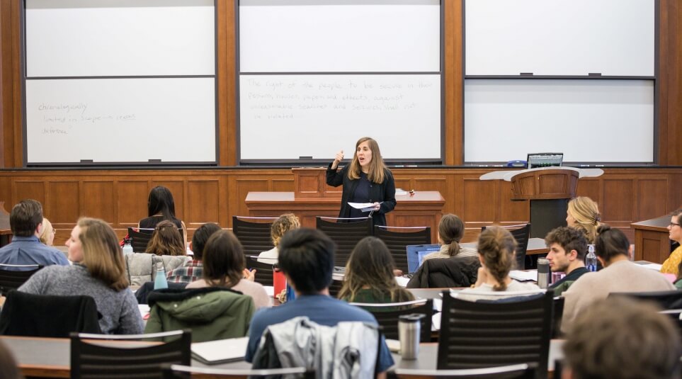 Professor Eve Primus teaching in front of a full classroom