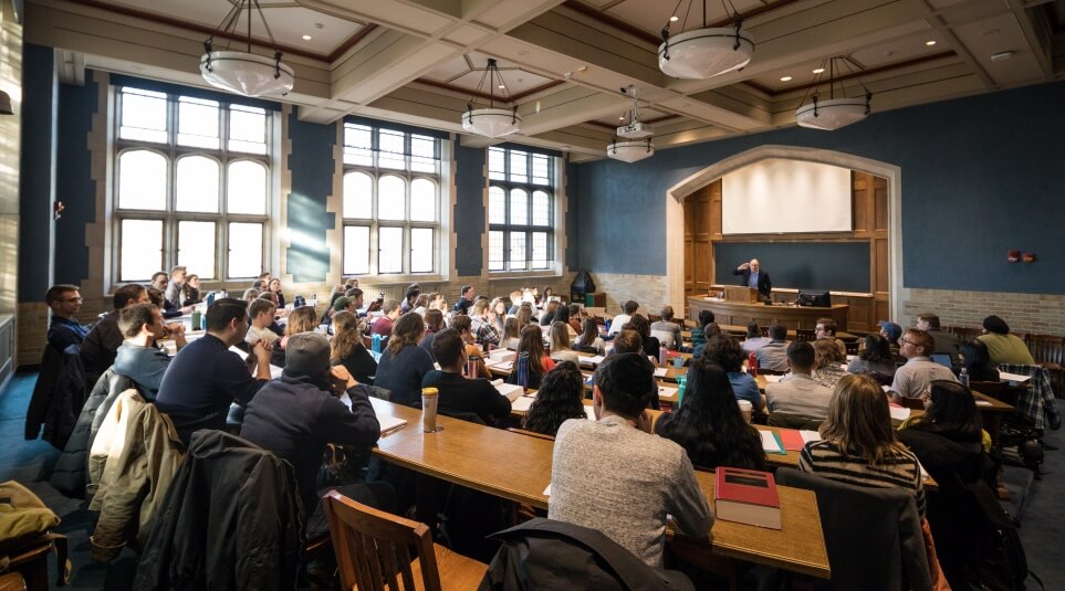 View of classroom full of students from the back of classroom with Richard Primus teaching.