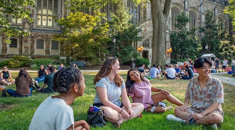 A group of Michigan Law students socializing outside in the Law Quad.