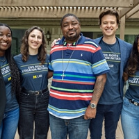 Four people standing together at a conference 