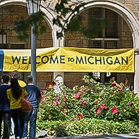 A "Welcome to Michigan" banner is hung outside the Lawyers Club, welcoming all who pass by.