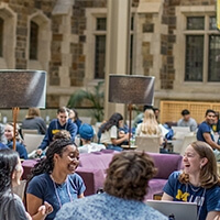 A group of Michigan Law students sitting together in the upper commons.
