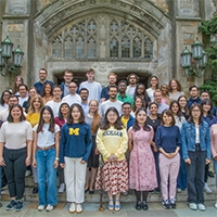 A group of LLM students pose for a portrait outside the Reading Room.