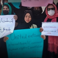A group of women holding protest signs.