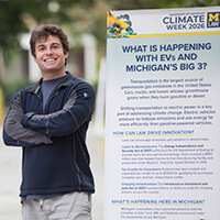 Ben Korn next to the Climate Week Exhibit in the Law Quad.